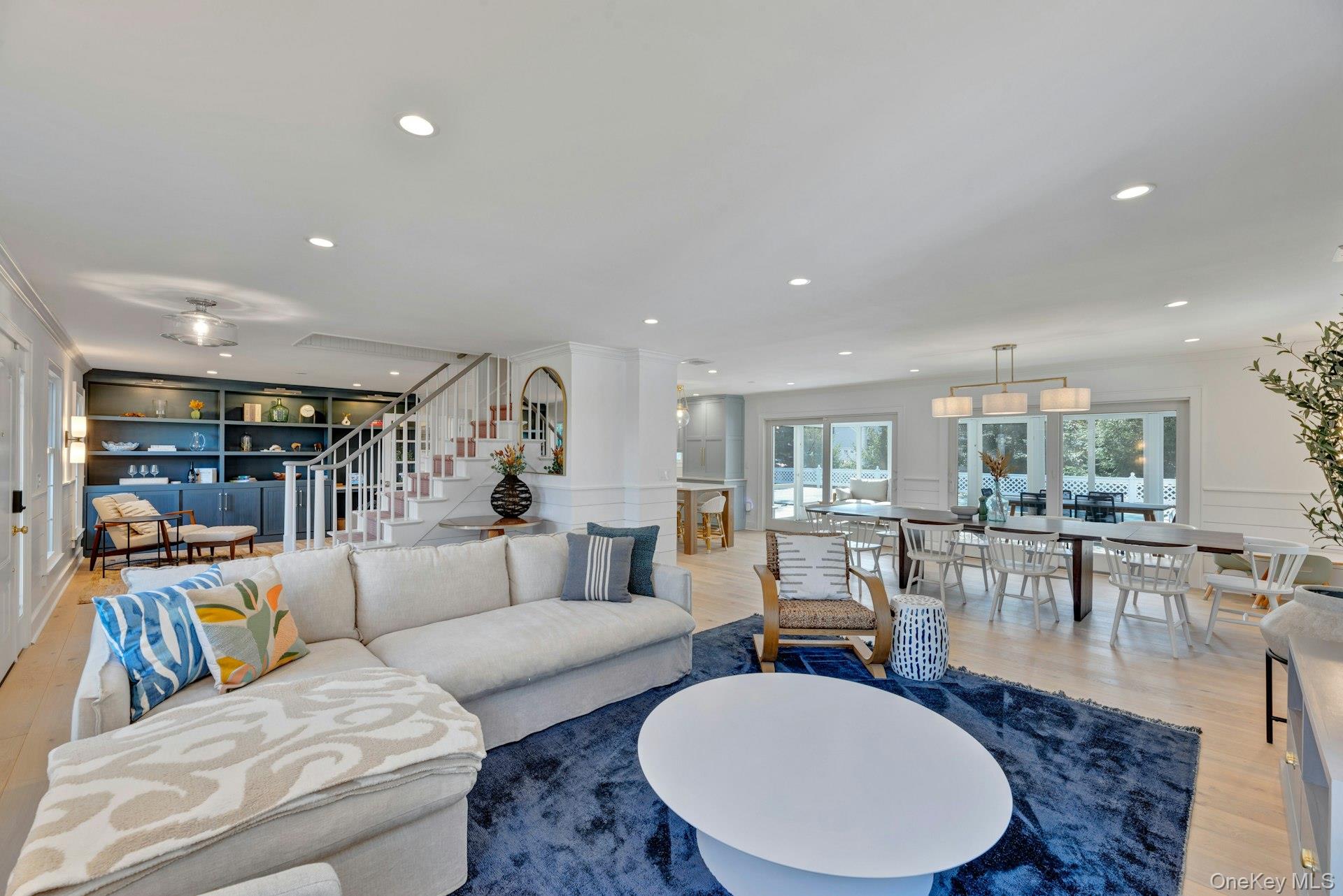 110 Sleepy Hollow Lane Southold, NY 11971 - Photo 4 of 46 Living area featuring wood finished floors, stairs, a decorative wall, recessed lighting, and built in features