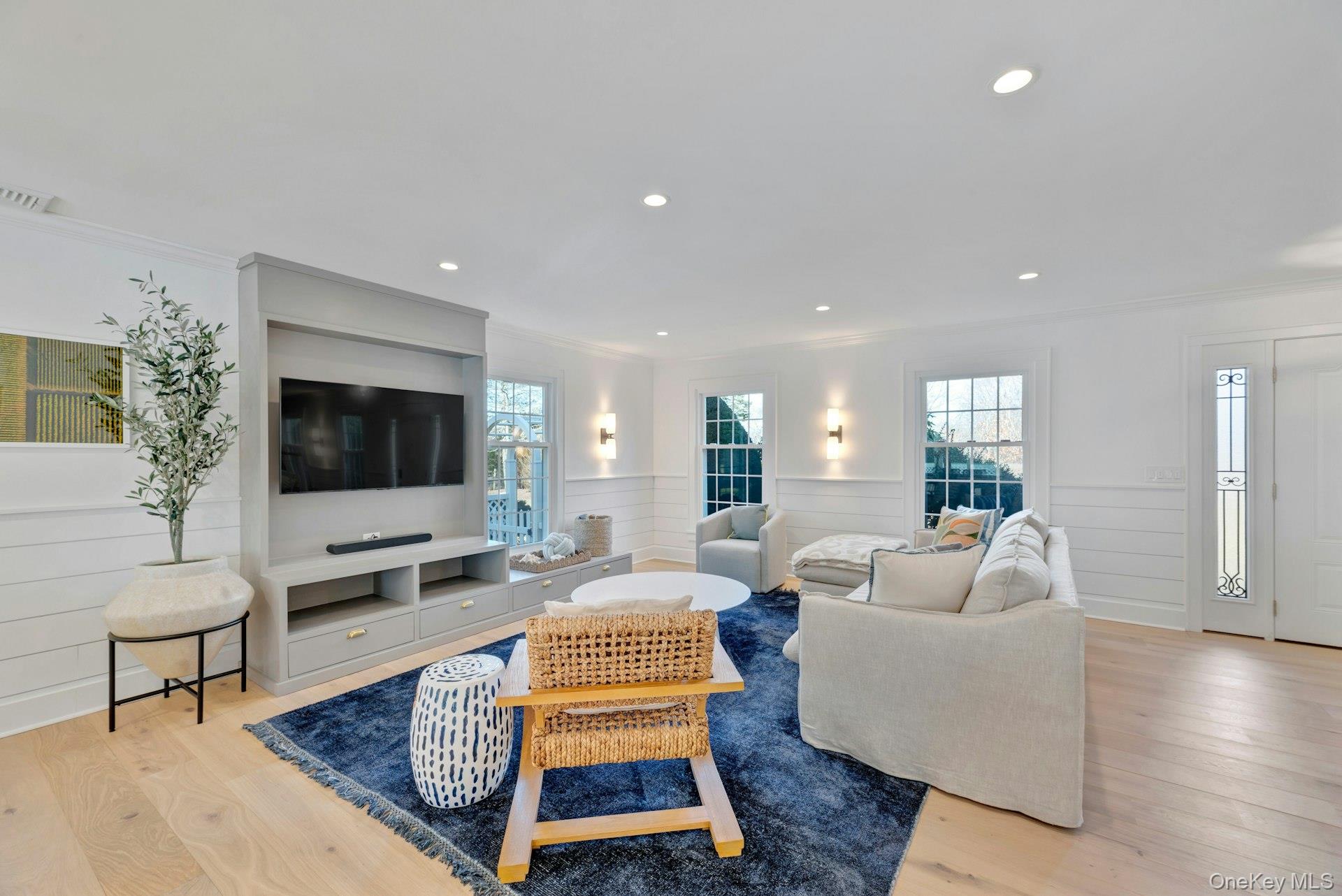 110 Sleepy Hollow Lane Southold, NY 11971 - Photo 6 of 46 Living area featuring light wood-style flooring, crown molding, wainscoting, and recessed lighting