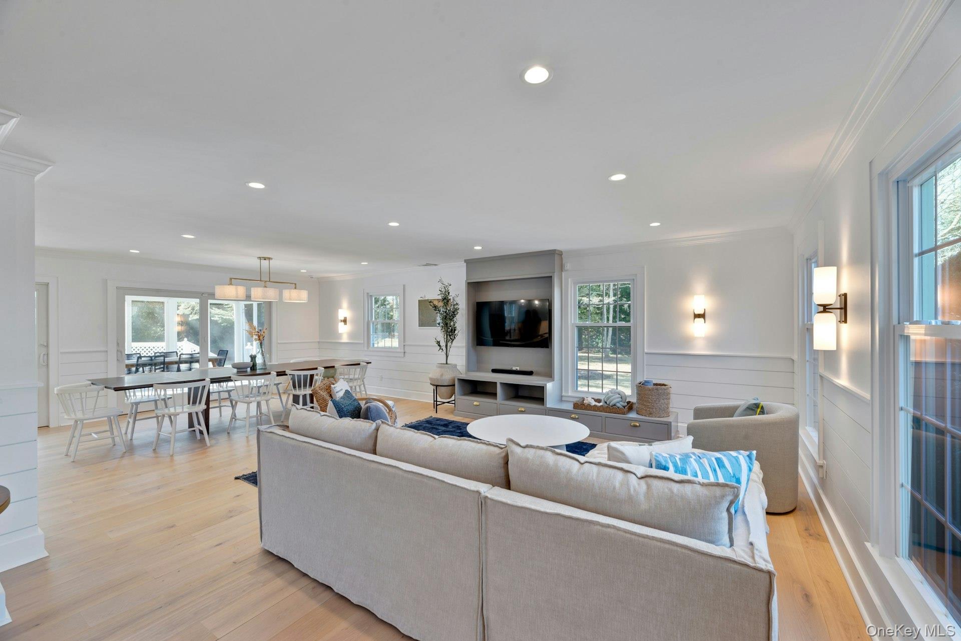 110 Sleepy Hollow Lane Southold, NY 11971 - Photo 7 of 46 Living area with plenty of natural light, wainscoting, light wood-style flooring, crown molding, and recessed lighting