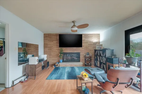 a living room with fireplace furniture and a flat screen tv