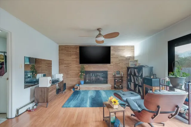 a living room with fireplace furniture and a flat screen tv