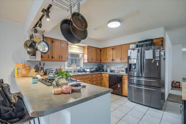 a kitchen with stainless steel appliances granite countertop a sink and a refrigerator