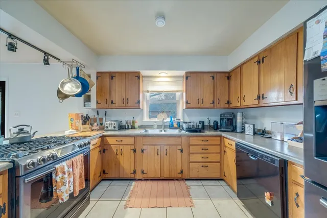 a kitchen with a sink cabinets and window