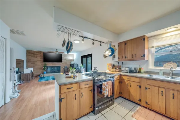 a kitchen with a sink stove and cabinets