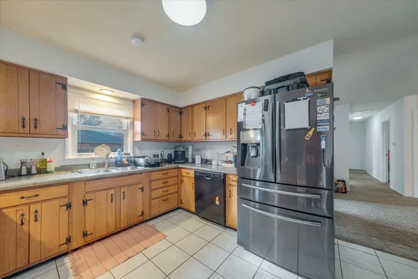 a kitchen with stainless steel appliances granite countertop a refrigerator sink and cabinets