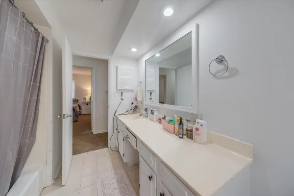 a bathroom with a sink a mirror and a bathtub