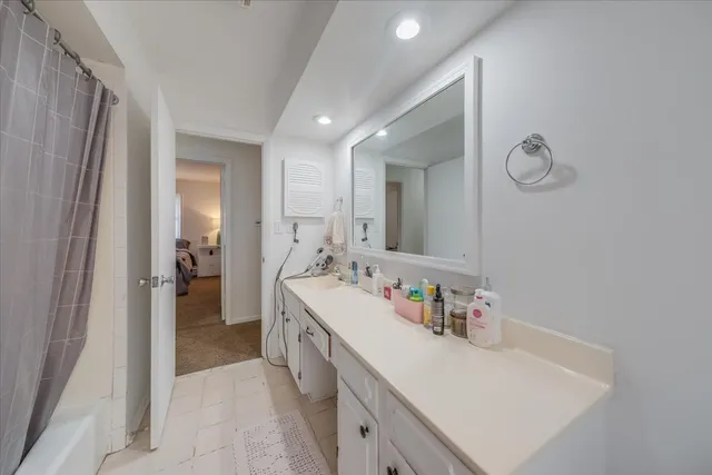 a bathroom with a sink a mirror and a bathtub