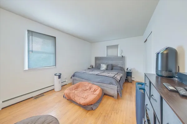 a bedroom with a bed and flat screen tv