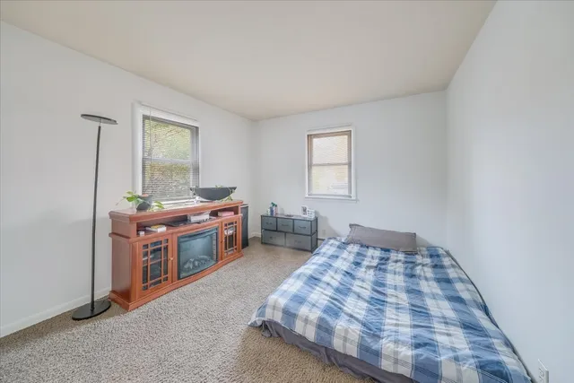 a bedroom with a bed and a dresser