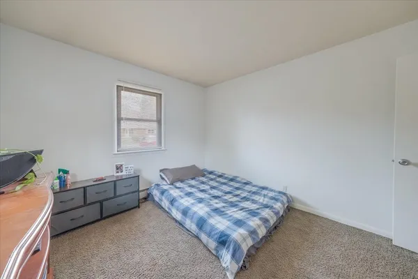 a bedroom with a bed and window