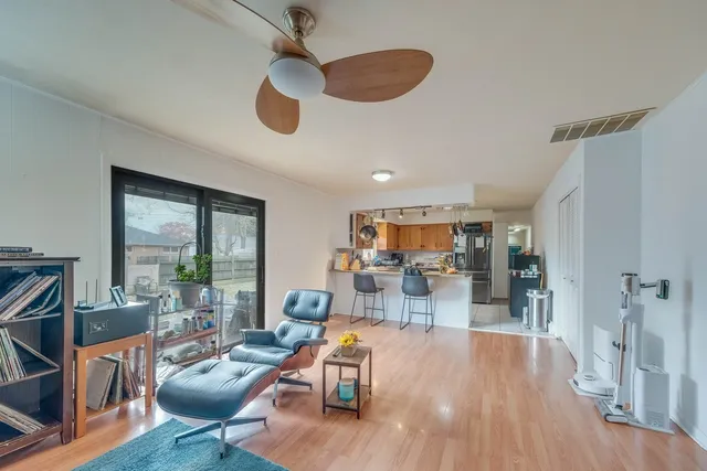 a living room with furniture and a wooden floor