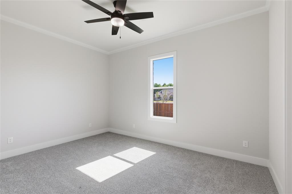 713 Anne Road Van Alstyne, TX 75495 - Photo 21 of 29 Bedroom featuring light gray carpeting, neutral wall paint, a ceiling fan with integrated lighting, a single window, and white crown molding