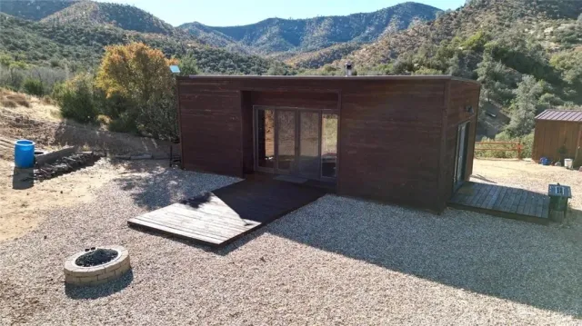 a view of a small house with a yard