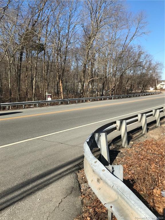 a view of swimming pool with outdoor seating and trees in the background