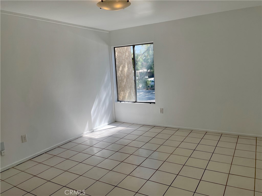 1000 West MacArthur Boulevard, Unit 87 Santa Ana, CA 92707 - Photo 12 of 36 an empty room with windows and entrance