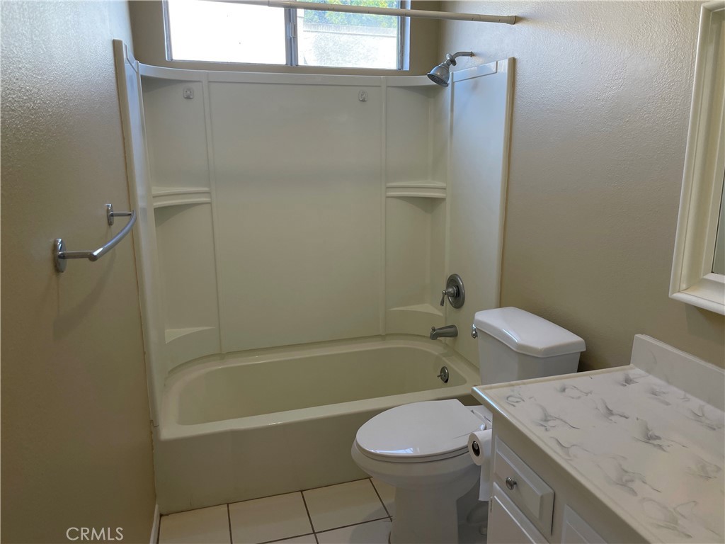 1000 West MacArthur Boulevard, Unit 87 Santa Ana, CA 92707 - Photo 9 of 36 a bathroom with a sink a toilet and shower