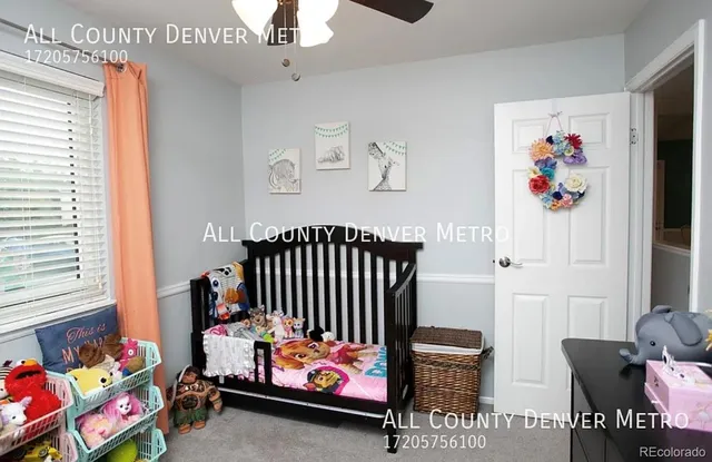 a bedroom with furniture and a book shelf