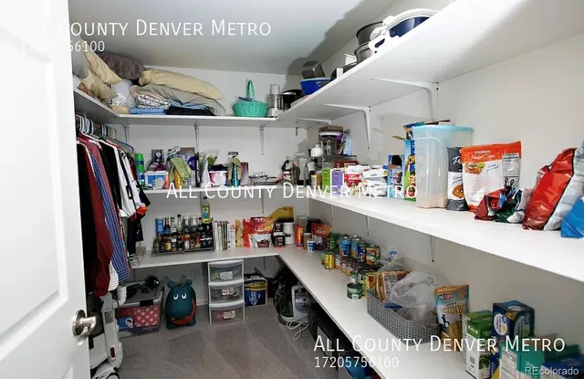 a view of a roof deck with table and chairs a barbeque with wooden floor and fence