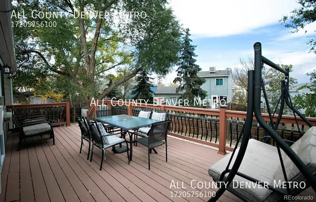a view of a deck with table and chairs and wooden floor