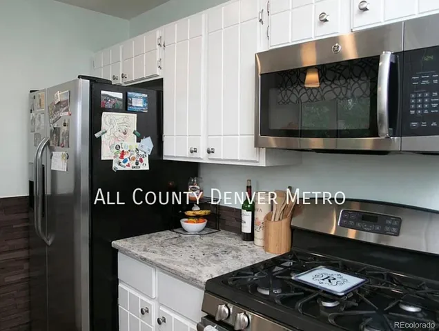 a kitchen with stainless steel appliances granite countertop a stove and a microwave