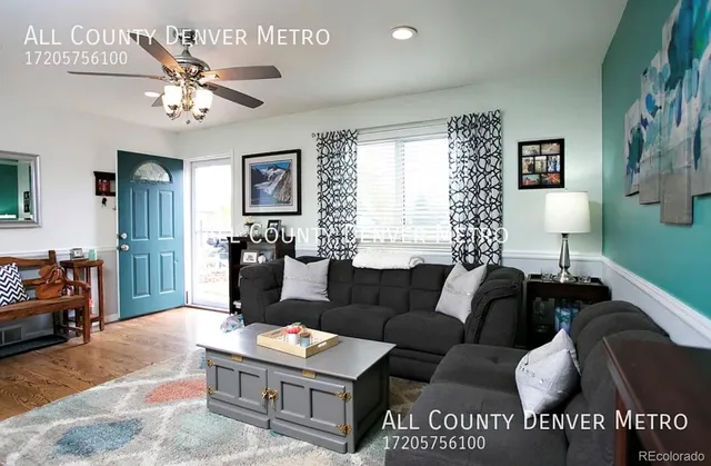 a living room with furniture a chandelier and a window