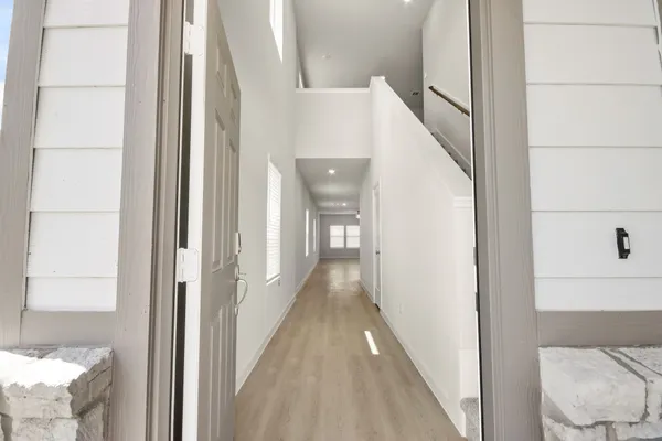 a view of a hallway with windows and stairs