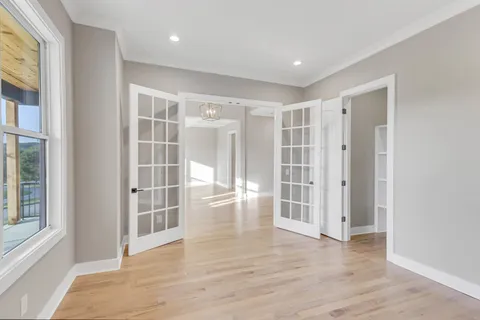 a view of empty room with wooden floor and fireplace