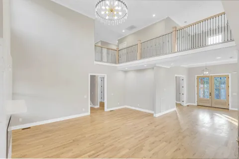 a large white kitchen with kitchen island a sink stainless steel appliances and cabinets
