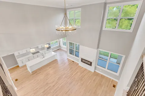 a spacious bedroom with a bed couch and a large window