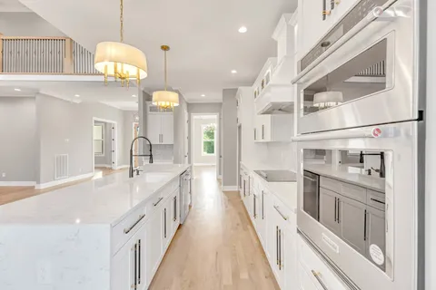a view of a hallway with windows and stairs