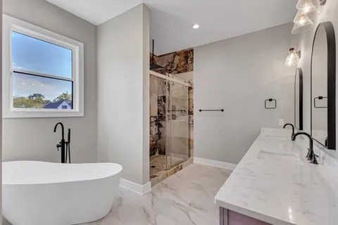 a bathroom with a granite countertop shower mirror and a sink