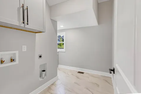 a view of a backyard with plants and large tree
