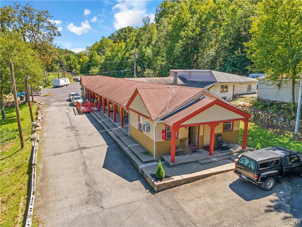 Undisclosed Address Saylorsburg, PA 18353 - Photo 2 of 18 a view of a patio with a table and chairs under an umbrella