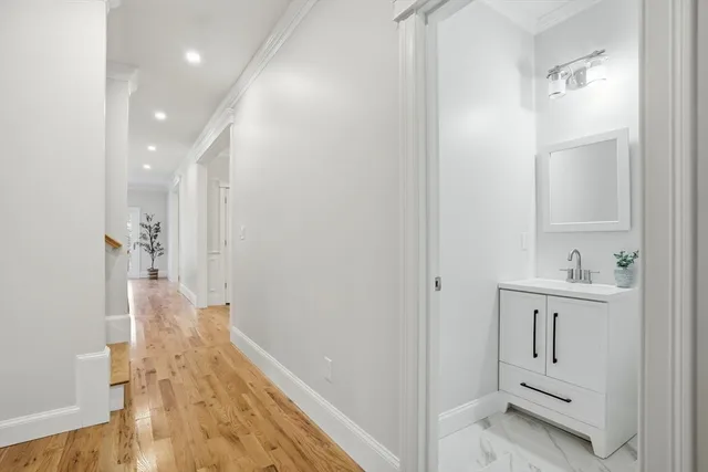 a view of a hallway with wooden floor and staircase