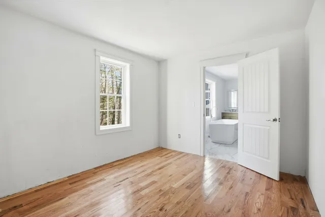 a view of a room with wooden floor and window