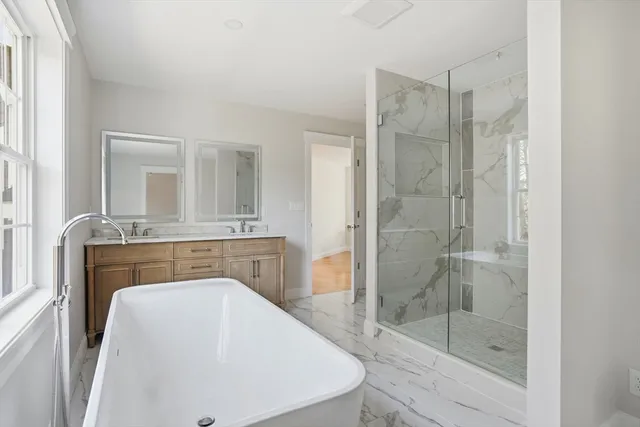 a bathroom with a shower a mirror and a sink