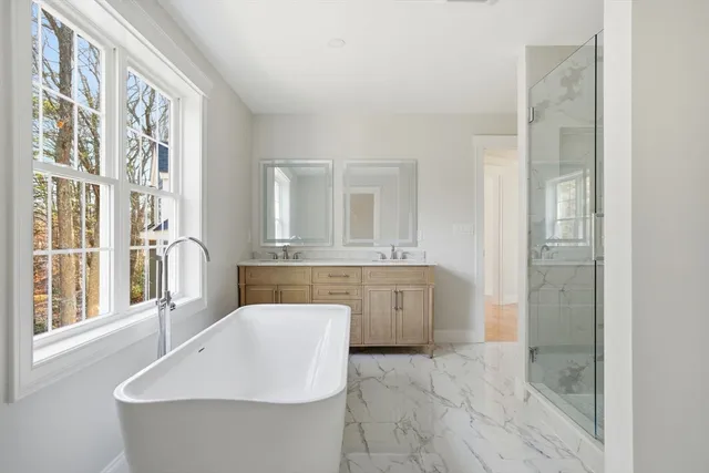 a bathroom with a bathtub sink and mirror