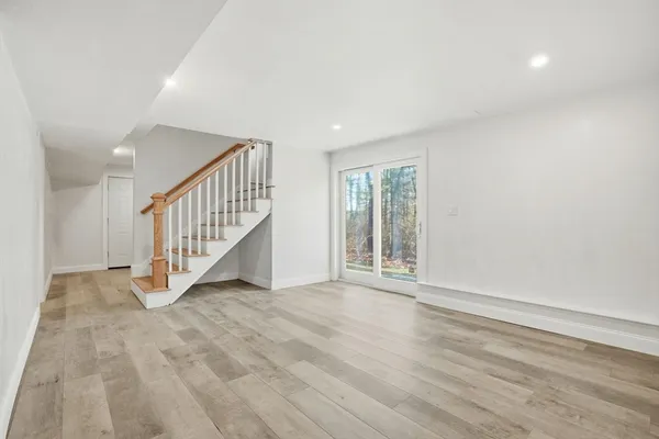 a view of an entryway with wooden floor