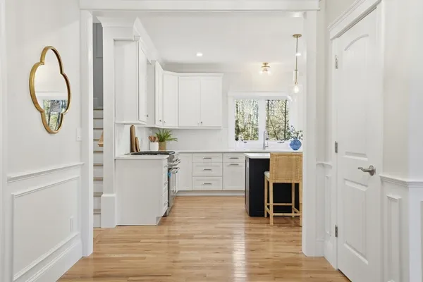 a kitchen with white cabinets and white appliances