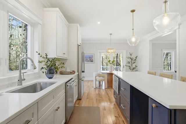 a kitchen with sink and refrigerator