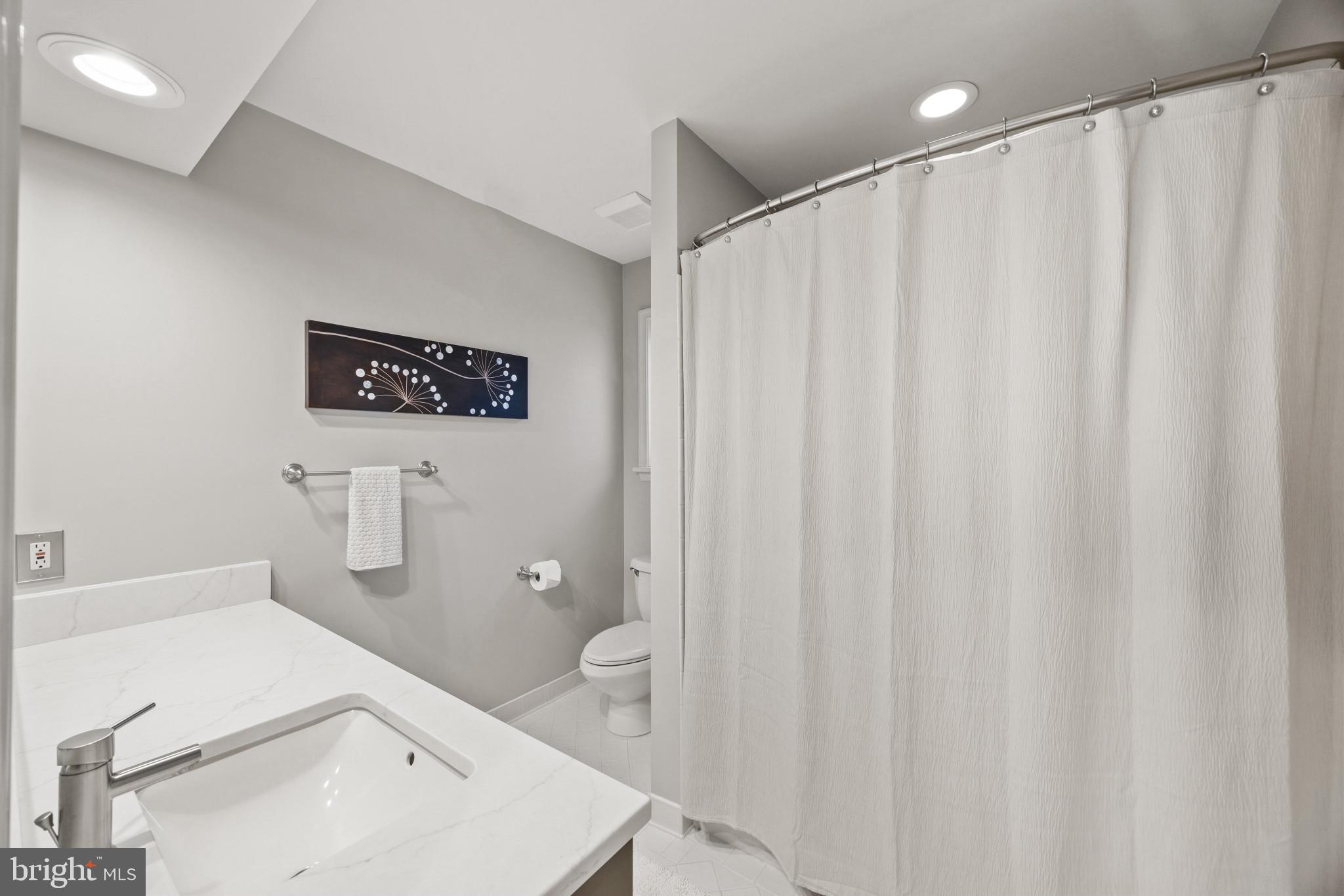 3403 Hidden River View Road Annapolis, MD 21403 - Photo 27 of 50 a bathroom with a sink a toilet and shower