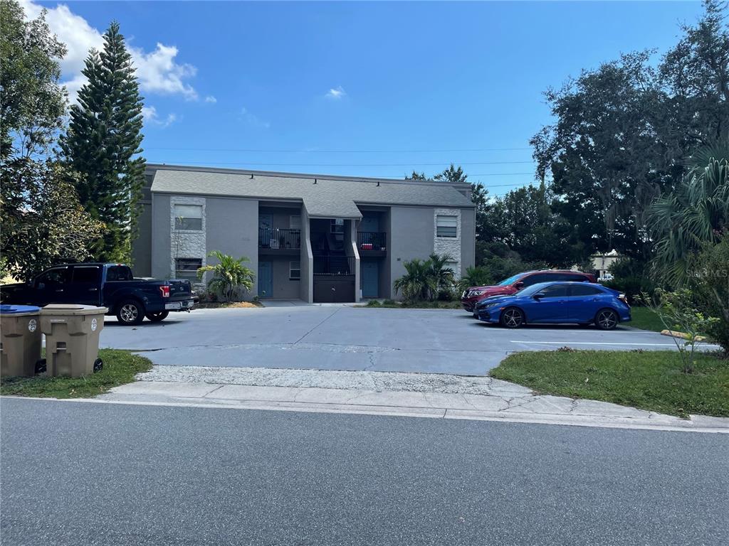 a front view of a house with a garden and yard