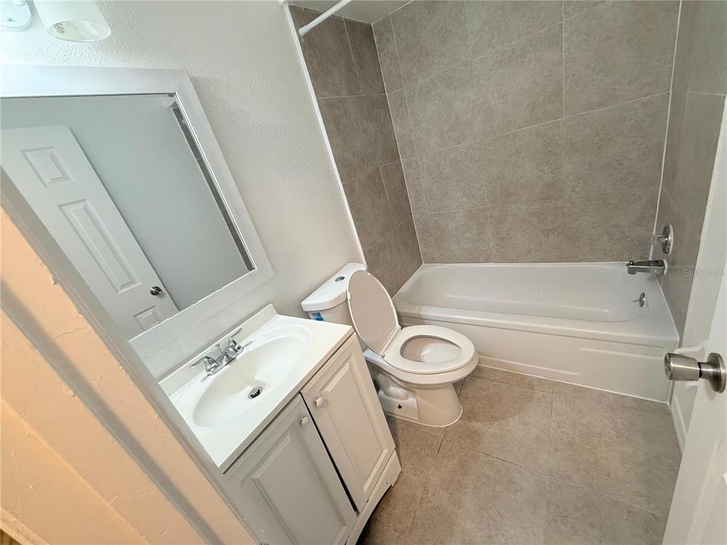 108 Booth Lane, Unit A Kissimmee, FL 34743 - Photo 16 of 19 a bathroom with a sink a toilet and bathtub