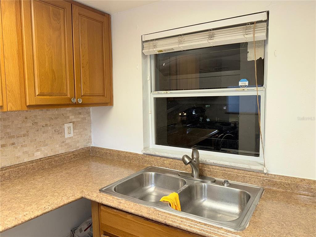 108 Booth Lane, Unit A Kissimmee, FL 34743 - Photo 17 of 19 a kitchen with a sink and a microwave