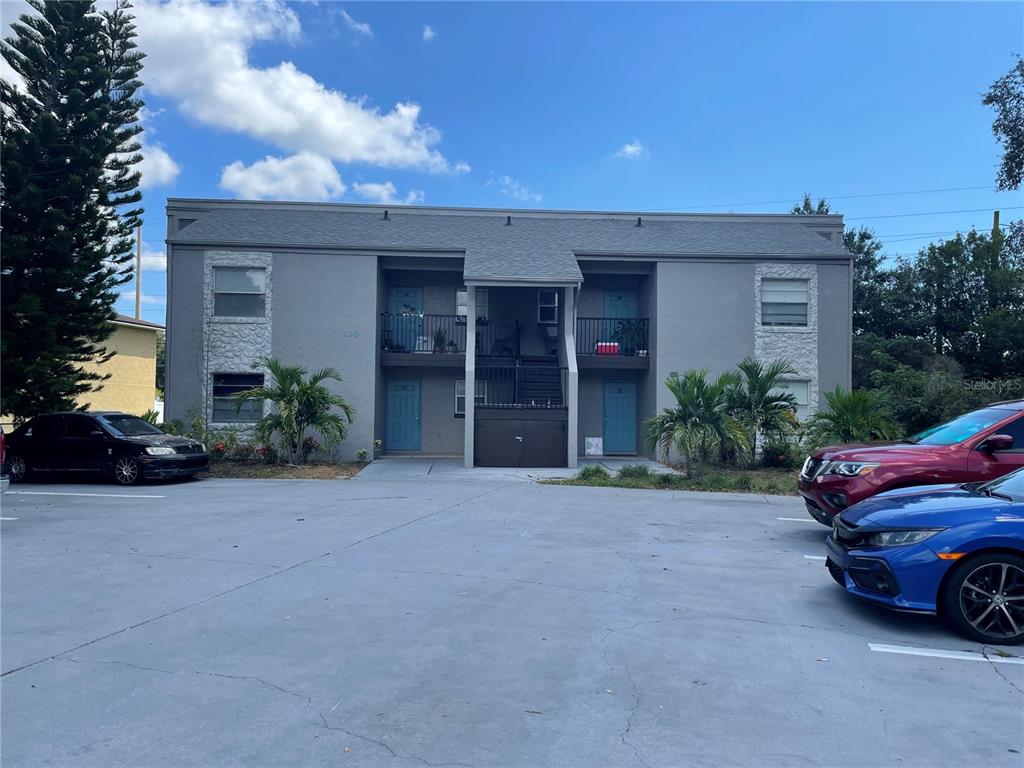 108 Booth Lane, Unit A Kissimmee, FL 34743 - Photo 2 of 19 a front view of a house with a yard and garage