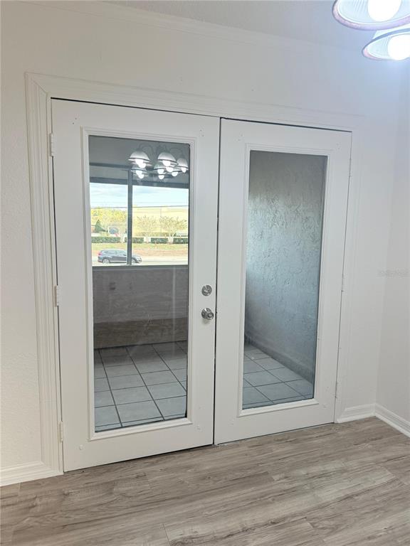 108 Booth Lane, Unit A Kissimmee, FL 34743 - Photo 7 of 19 a view of an empty room with wooden floor and a window