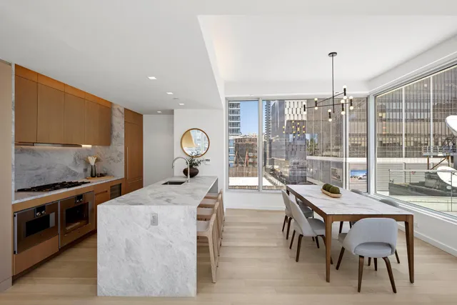 a living room with patio furniture and a wooden floor
