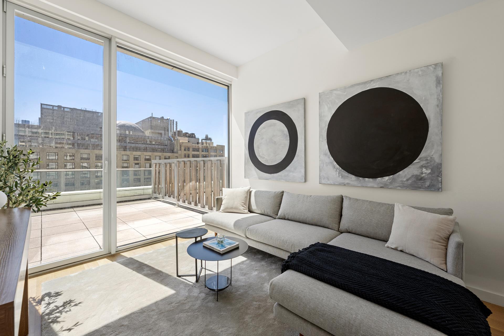611 West 56th Street, Unit MAIS-ONWEST Manhattan, NY 10019 - Photo 30 of 38 a living room with furniture and a large window