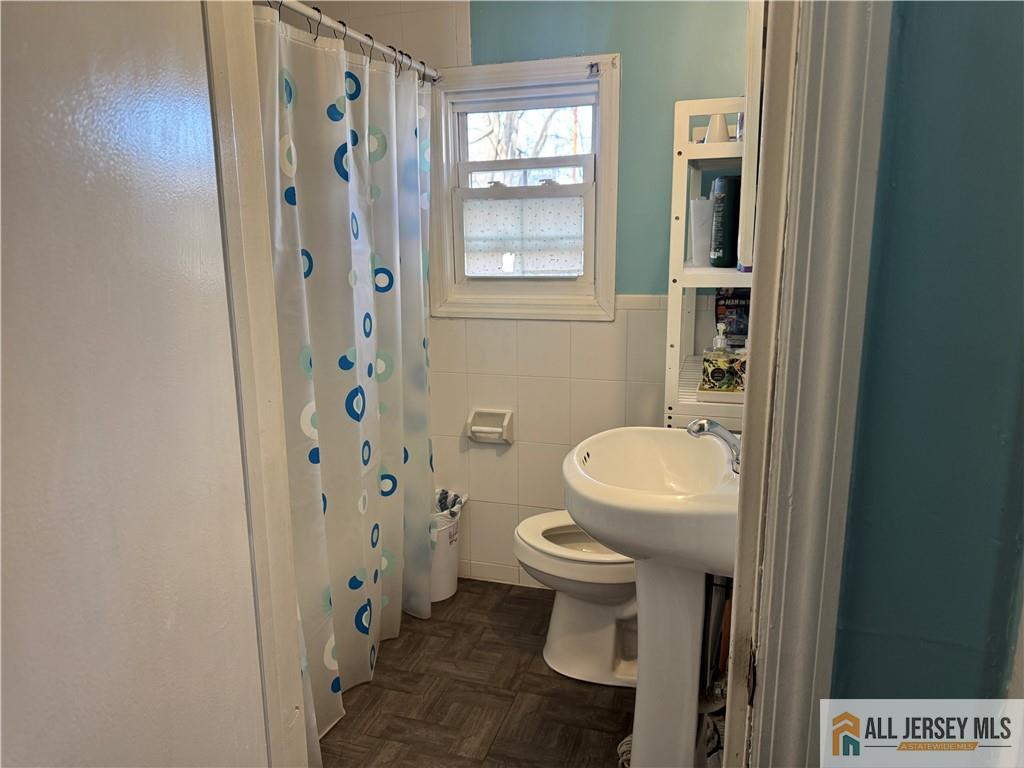 111 Delavan Street New Brunswick, NJ 08901 - Photo 12 of 28 a bathroom with a toilet and a shower