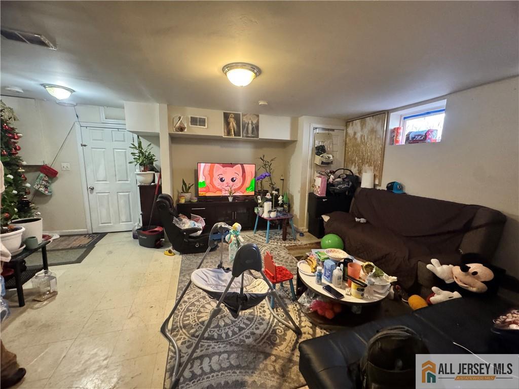 111 Delavan Street New Brunswick, NJ 08901 - Photo 17 of 28 a living room with furniture and a flat screen tv